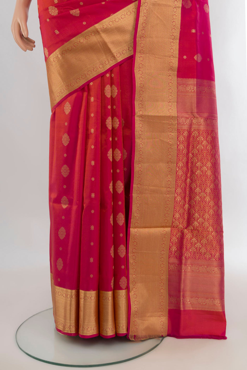 Pleats and pallu of Pure Silk Orange Soft Saree with Zari Butta on the body and Zari Border. 