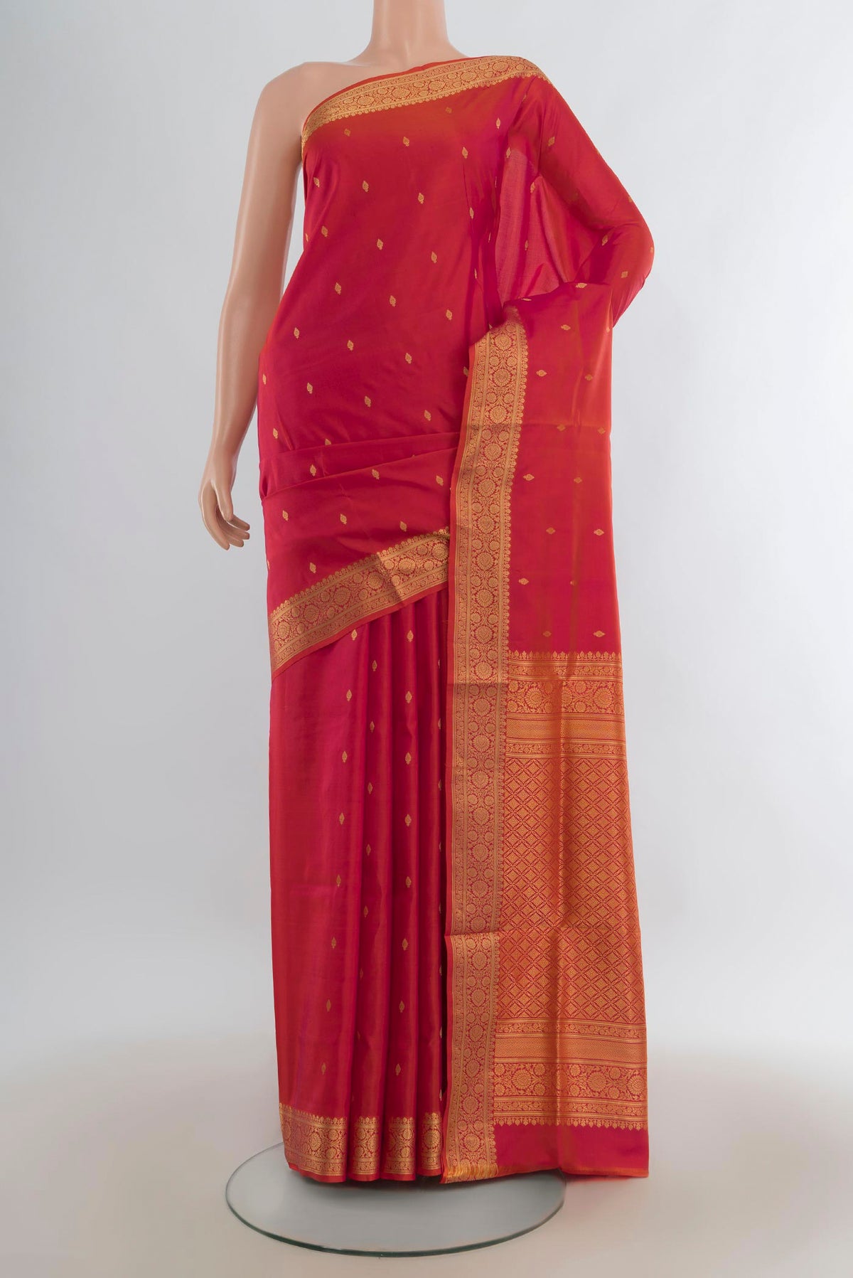 Pure Silk Brick Orange Dual Tone Soft Saree with Zari Butta on the body and Zari Border.  displayed on a mannequin