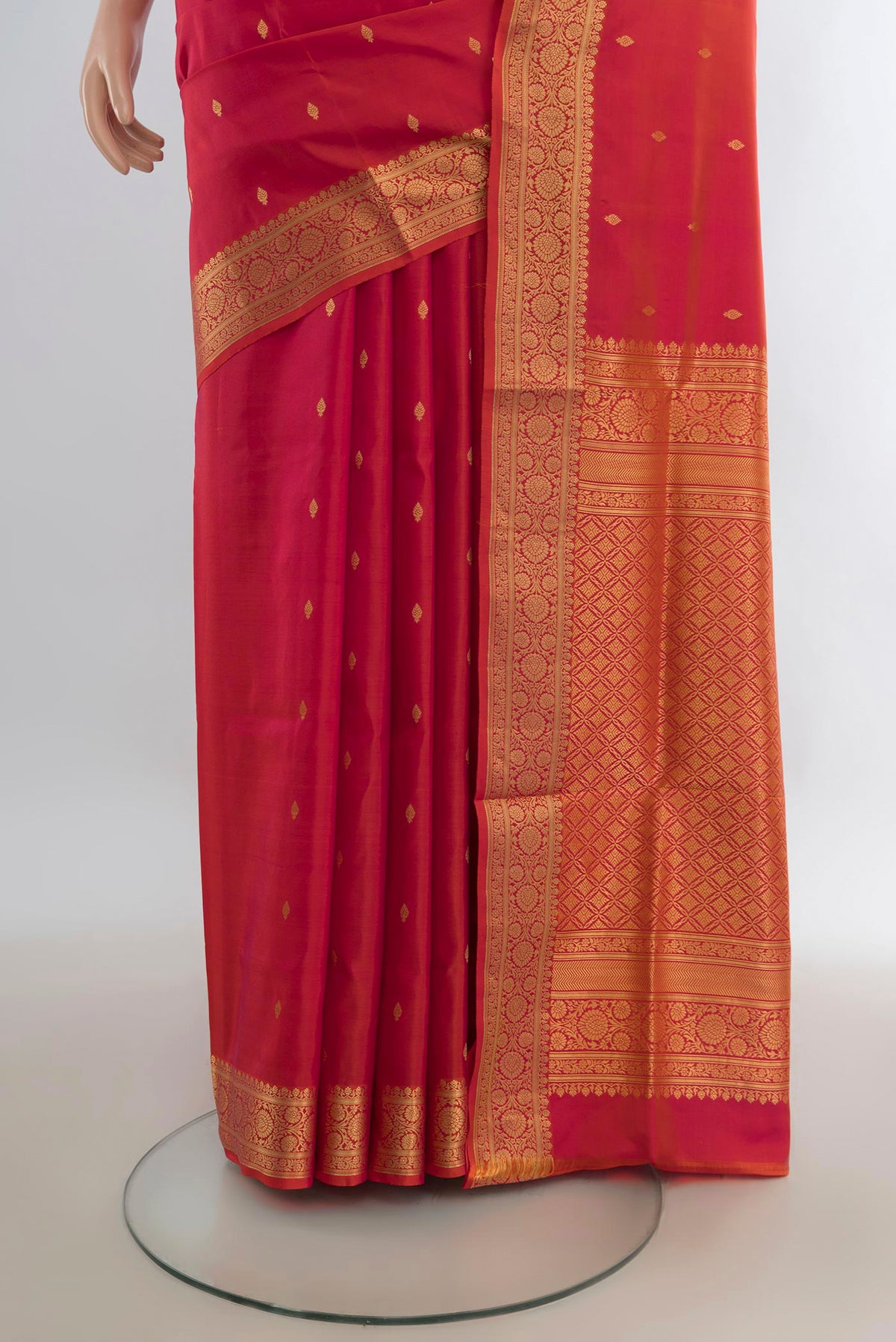 Pleats and pallu of Pure Silk Brick Orange Dual Tone Soft Saree with Zari Butta on the body and Zari Border. 
