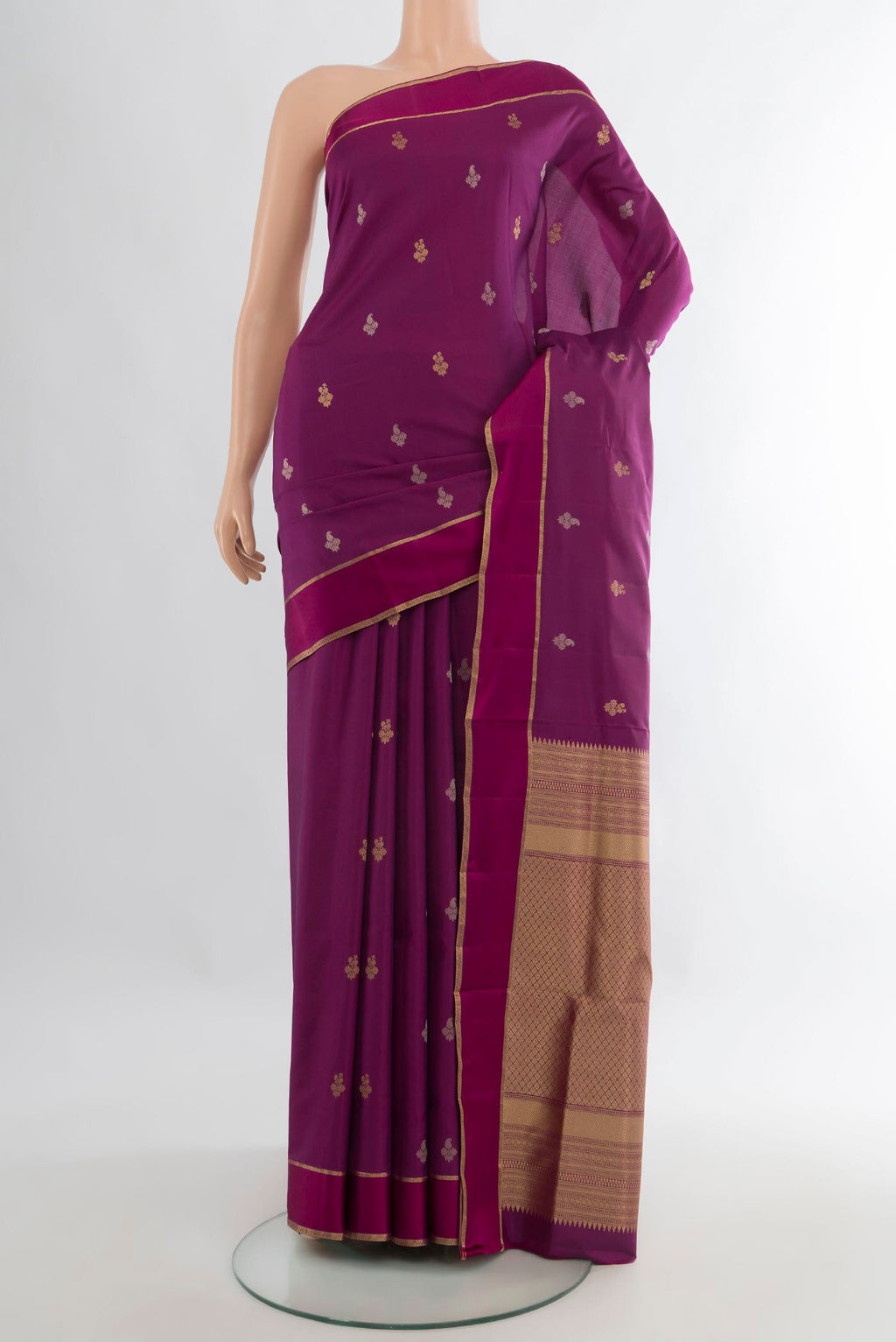 Pure Silk Magenta Kanchipuram Saree with Zari Butta on the body and Plain Border.  displayed on a mannequin