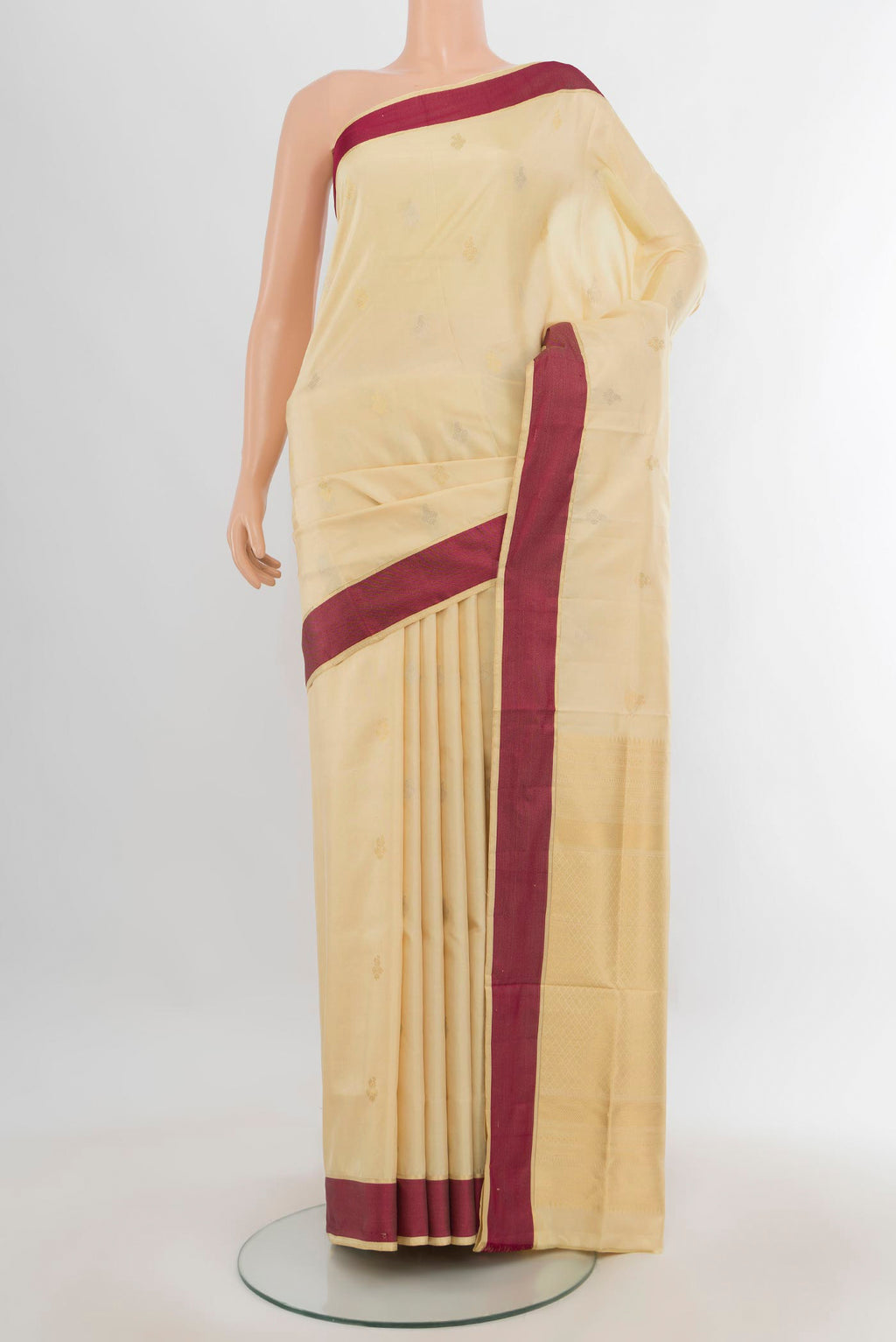 Pure Silk Sandal Soft Saree with Zari Butta on the body and Thread Border.  displayed on a mannequin