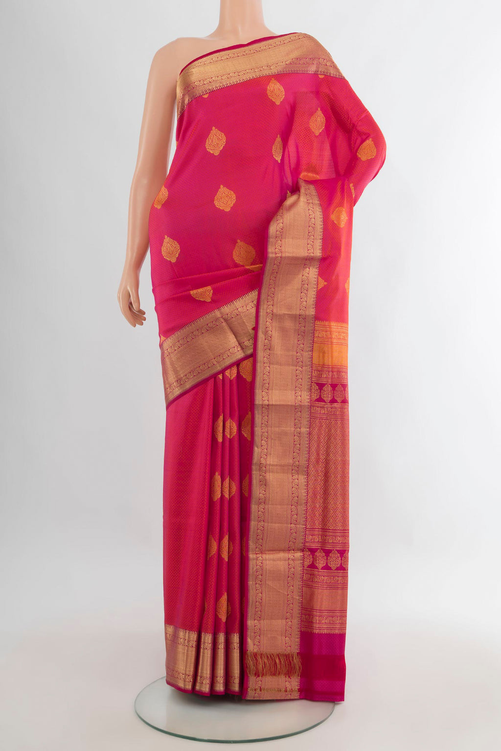 Pure Silk Coral Soft Saree with Zari Butta on the body and Zari Border.  displayed on a mannequin