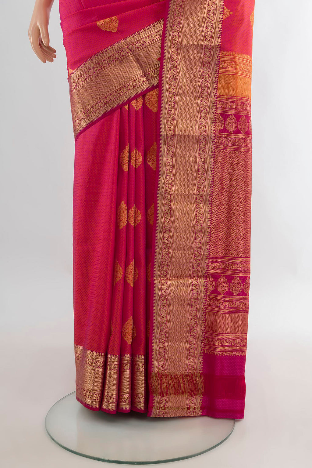 Pleats and pallu of Pure Silk Coral Soft Saree with Zari Butta on the body and Zari Border. 