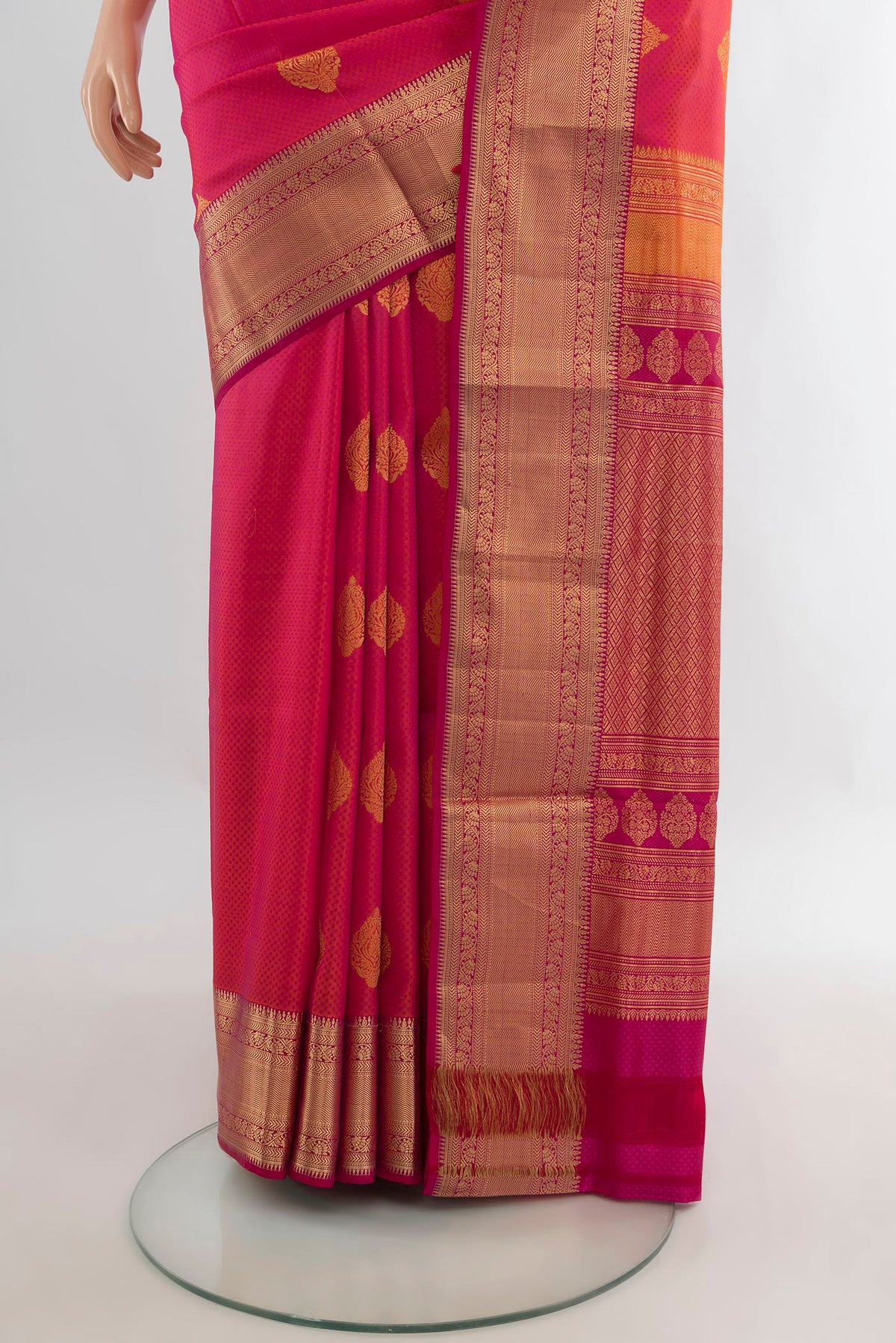 Pleats and pallu of Pure Silk Coral Soft Saree with Zari Butta on the body and Zari Border. 