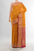 Pure Silk Mustard Soft Saree with Zari Butta on the body and Zari Border.  displayed on a mannequin