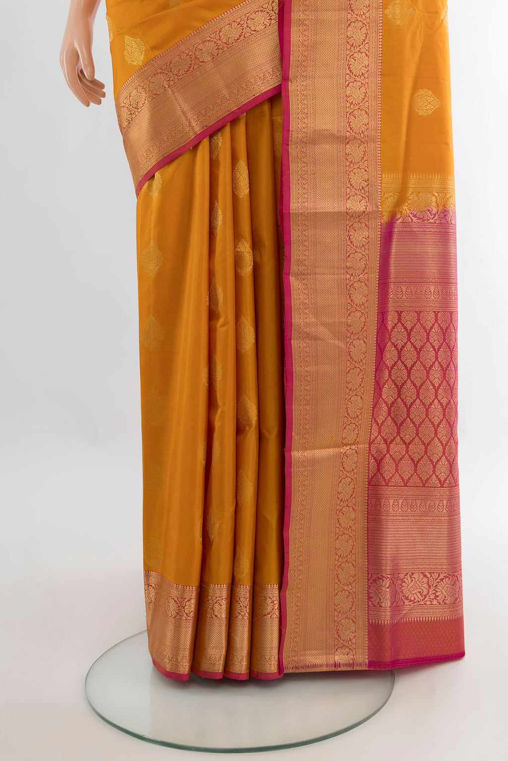 Pleats and pallu of Pure Silk Mustard Soft Saree with Zari Butta on the body and Zari Border. 