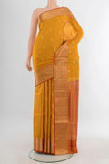Pure Silk Mustard Soft Saree with Zari Butta on the body and Zari Border.  displayed on a mannequin