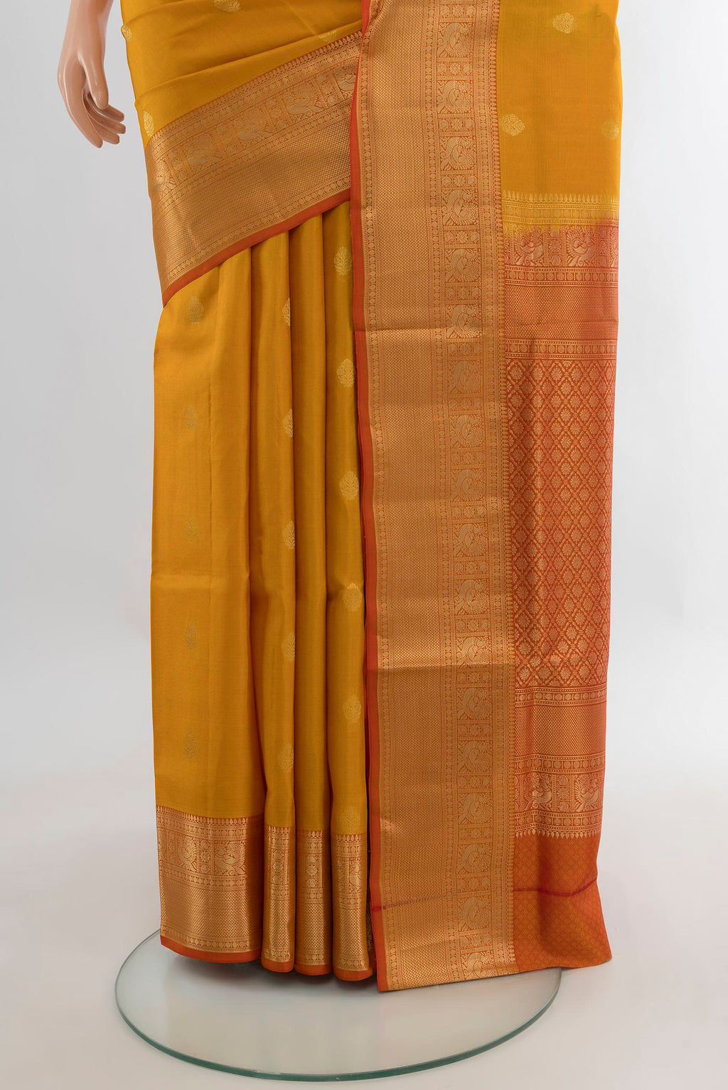 Pleats and pallu of Pure Silk Mustard Soft Saree with Zari Butta on the body and Zari Border. 