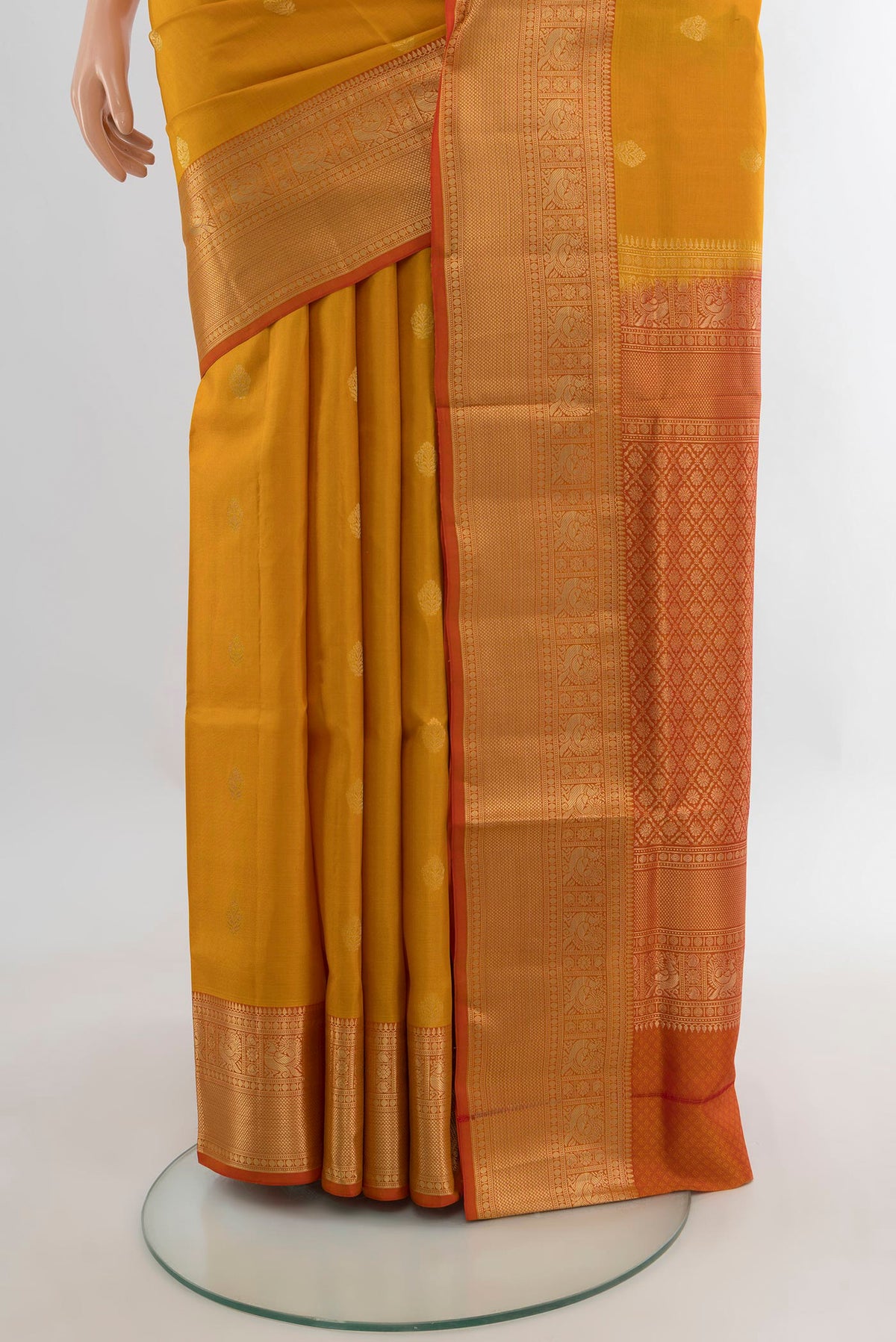 Pleats and pallu of Pure Silk Mustard Soft Saree with Zari Butta on the body and Zari Border. 