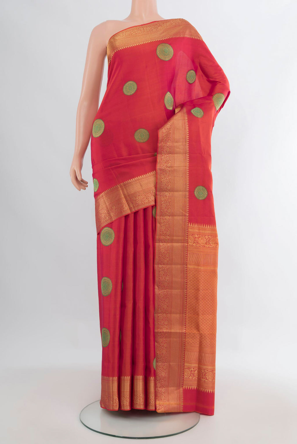 Pure Silk Orange Soft Saree with Zari And Thread Butta on the body and Zari Border.  displayed on a mannequin