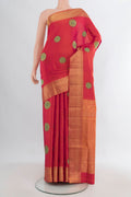 Pure Silk Orange Soft Saree with Zari And Thread Butta on the body and Zari Border.  displayed on a mannequin