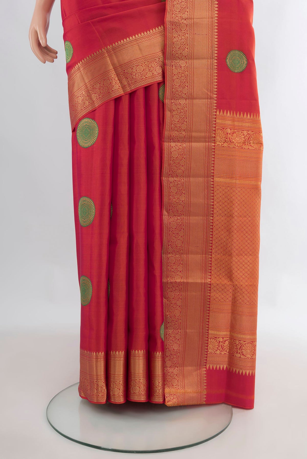 Pleats and pallu of Pure Silk Orange Soft Saree with Zari And Thread Butta on the body and Zari Border. 