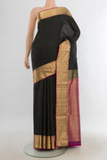 Pure Silk Black Soft Saree with Zari Butta on the body and Silk Border.  displayed on a mannequin