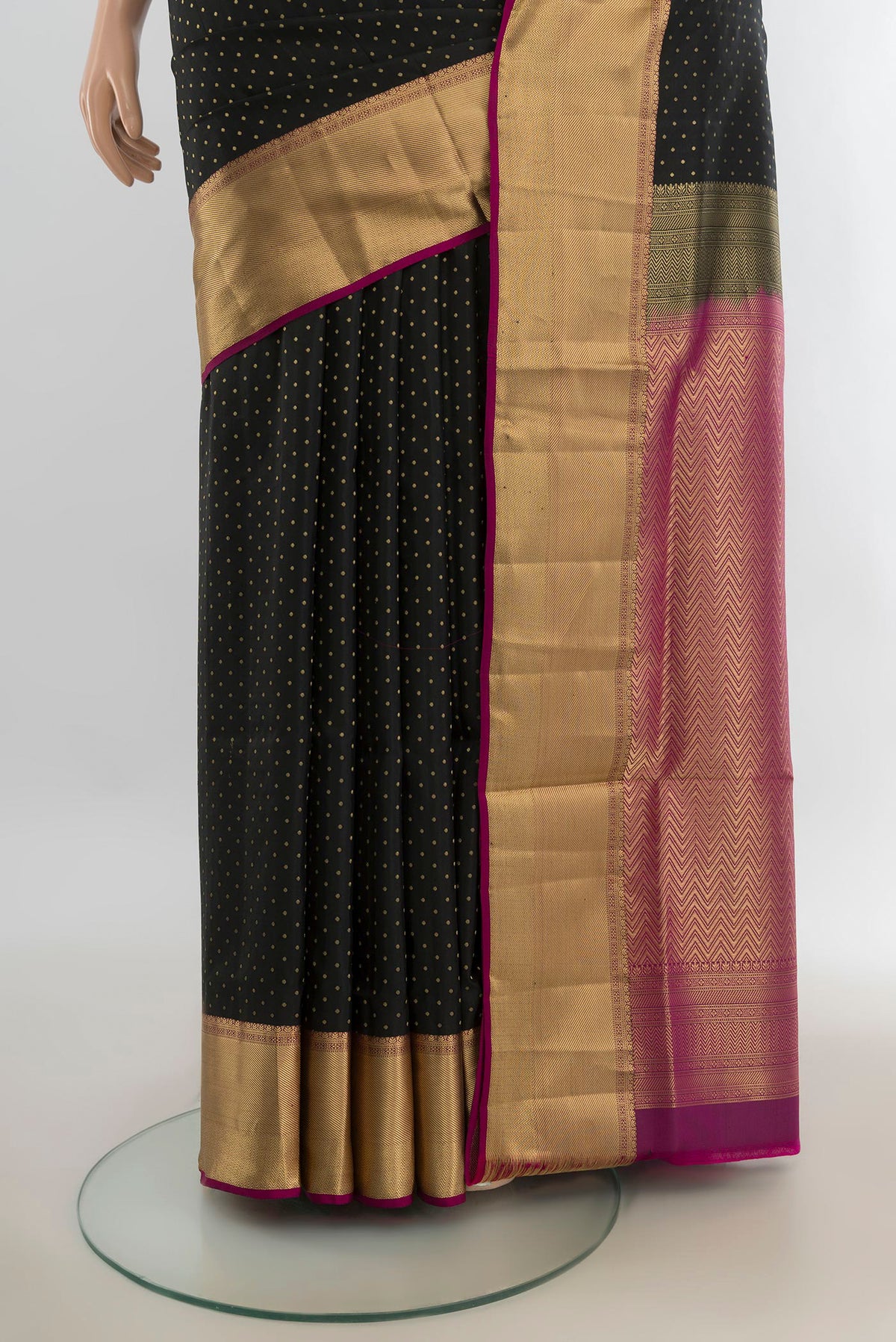 Pleats and pallu of Pure Silk Black Soft Saree with Zari Butta on the body and Silk Border. 