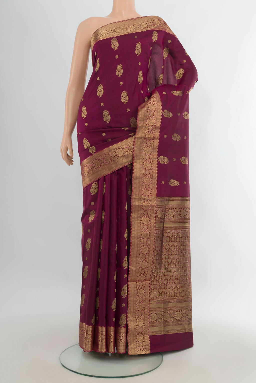 Pure Silk Maroon Soft Saree with Zari Butta on the body and Zari Border.  displayed on a mannequin