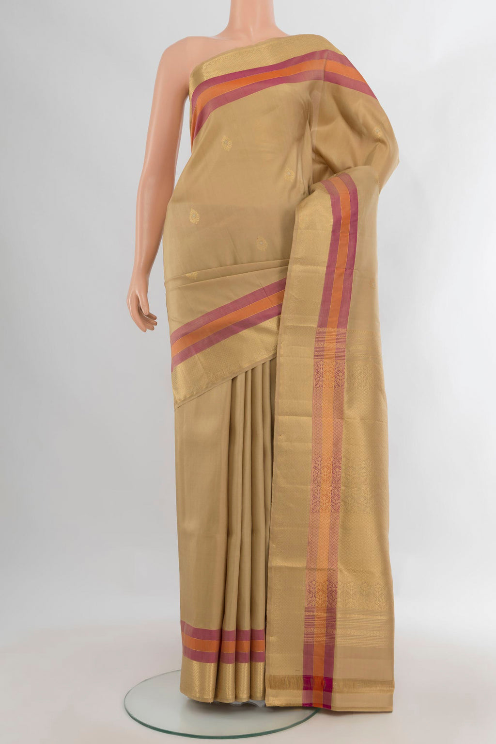 Pure Silk Sandal Soft Saree with Zari Butta on the body and Zari Border.  displayed on a mannequin
