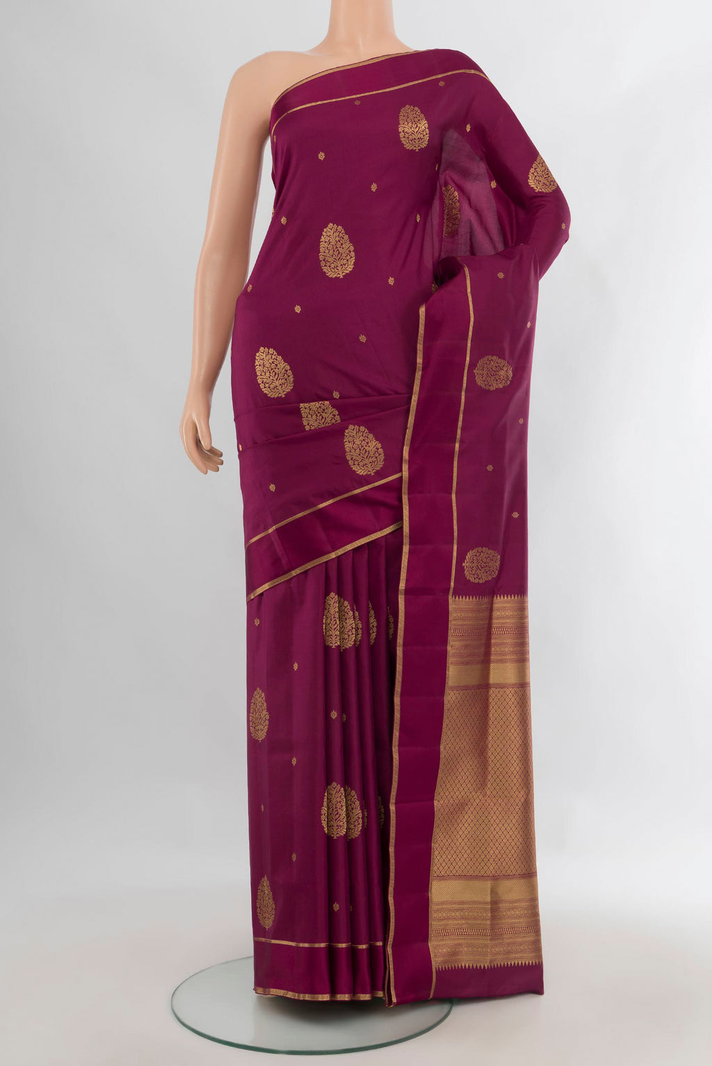 Pure Silk Maroon Soft Saree with Zari Butta on the body and Plain Border.  displayed on a mannequin