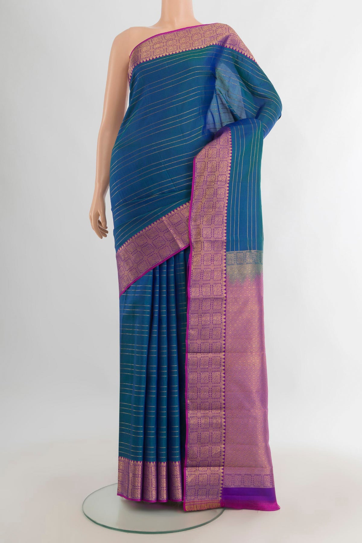 Pure Silk Peacock Blue Kanchipuram Saree with Stripes on the body and Zari Border.  displayed on a mannequin