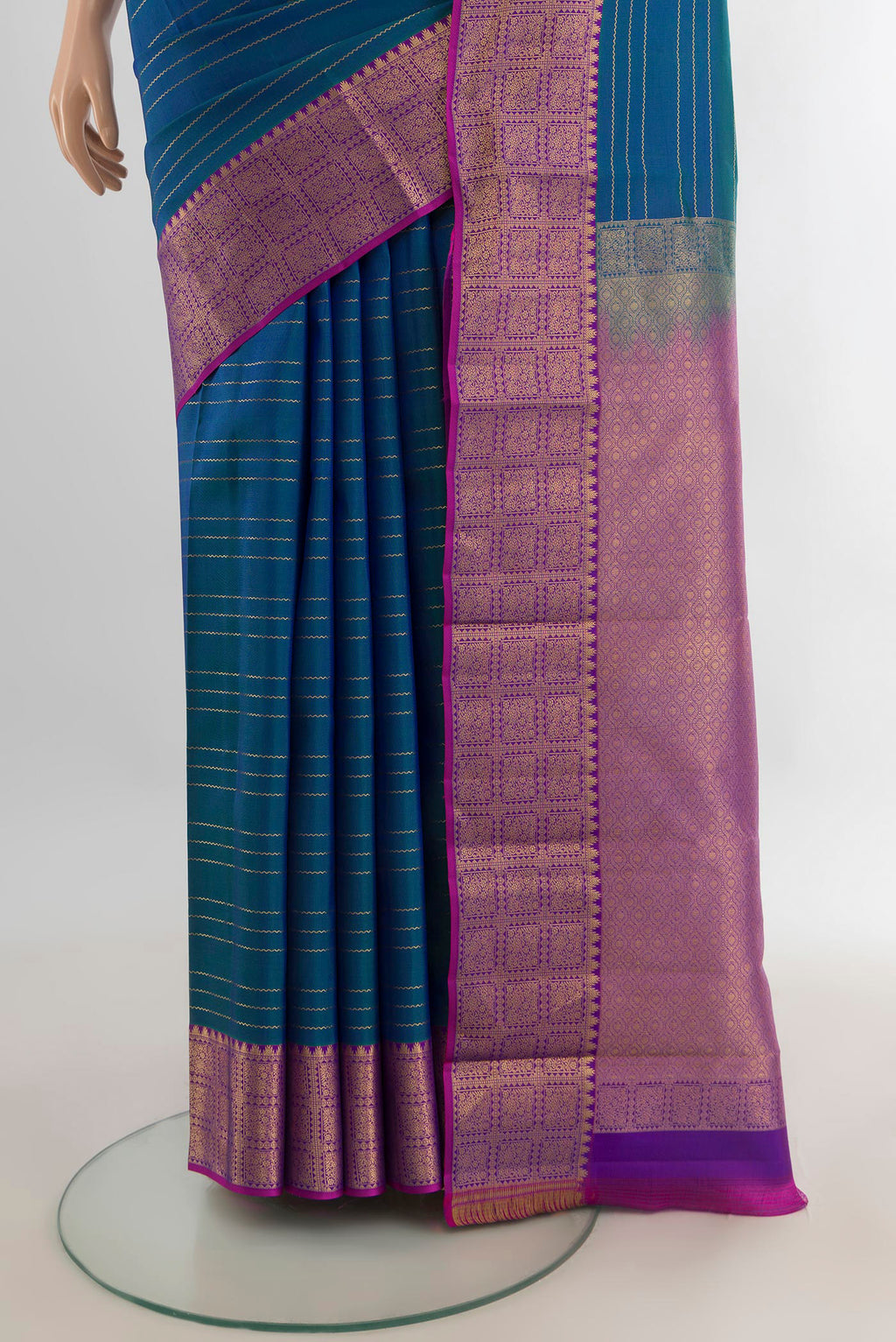 Pleats and pallu of Pure Silk Peacock Blue Kanchipuram Saree with Stripes on the body and Zari Border. 