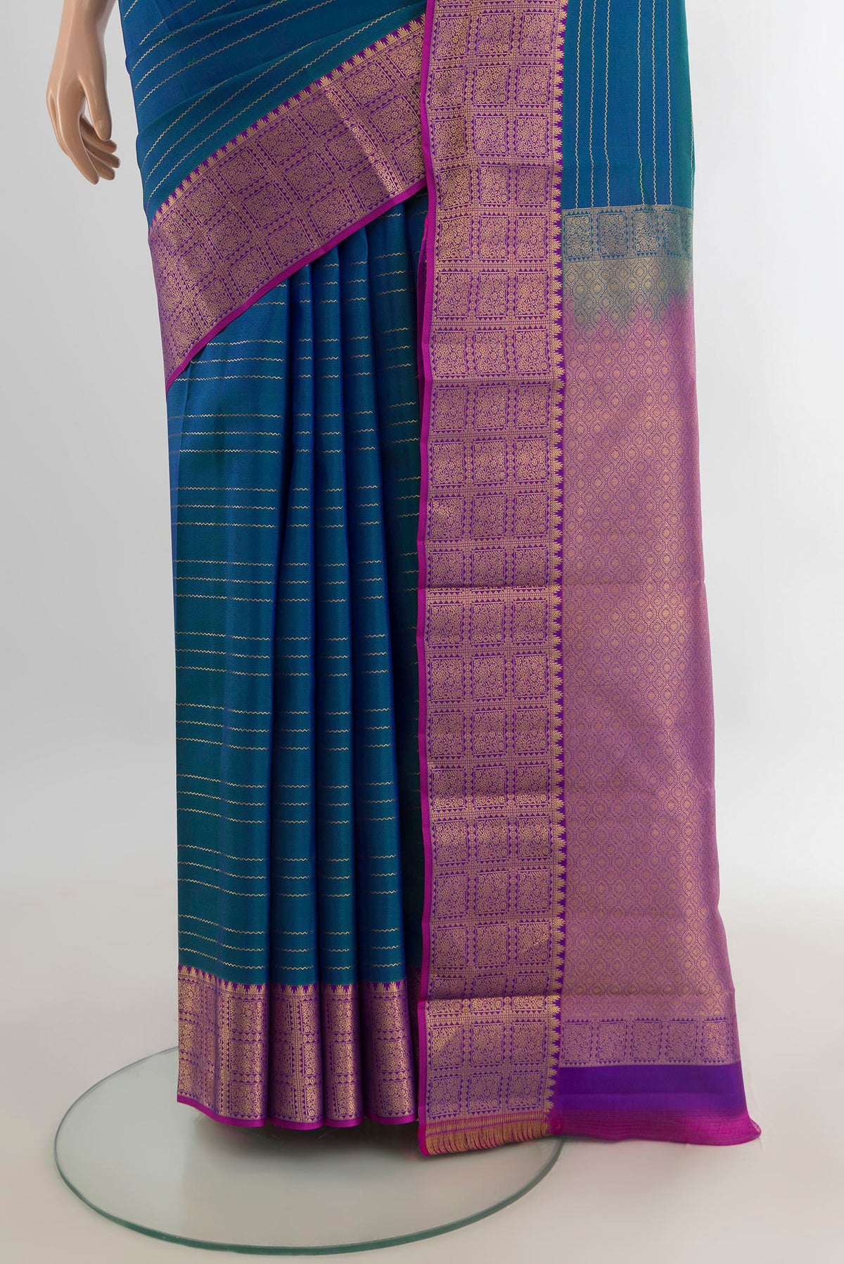 Pleats and pallu of Pure Silk Peacock Blue Kanchipuram Saree with Stripes on the body and Zari Border. 
