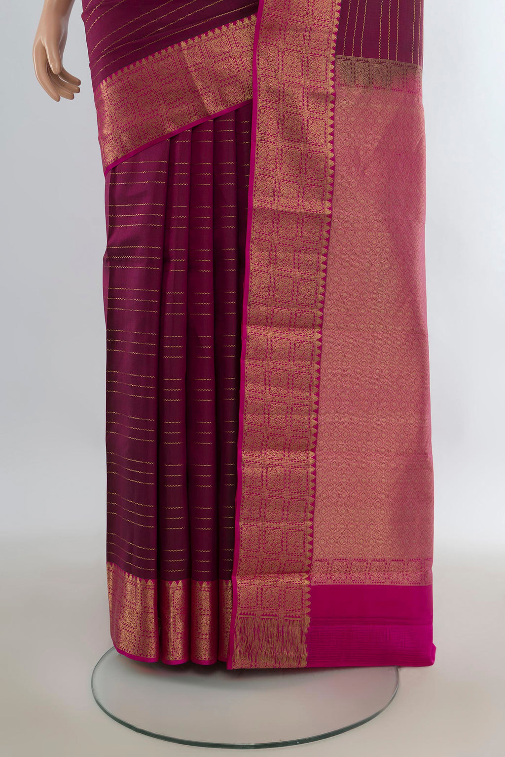 Pleats and pallu of Pure Silk Maroon Kanchipuram Saree with Zari Butta on the body and Zari Border. 