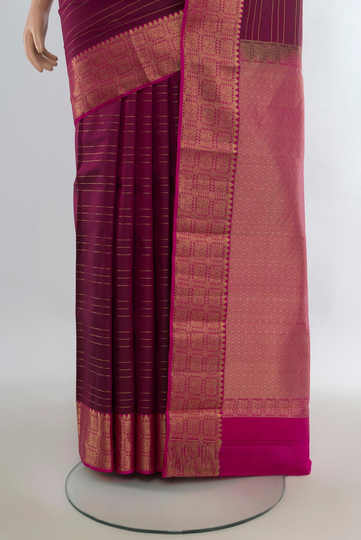 Pleats and pallu of Pure Silk Maroon Kanchipuram Saree with Zari Butta on the body and Zari Border. 