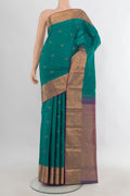 Pure Silk Green Kanjivaram Saree with Zari Butta on the body and Zari Border.  displayed on a mannequin