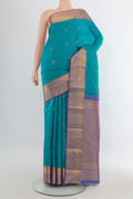 Pure Silk Turquoise Kanjivaram Saree with Zari Butta on the body and Zari Border.  displayed on a mannequin