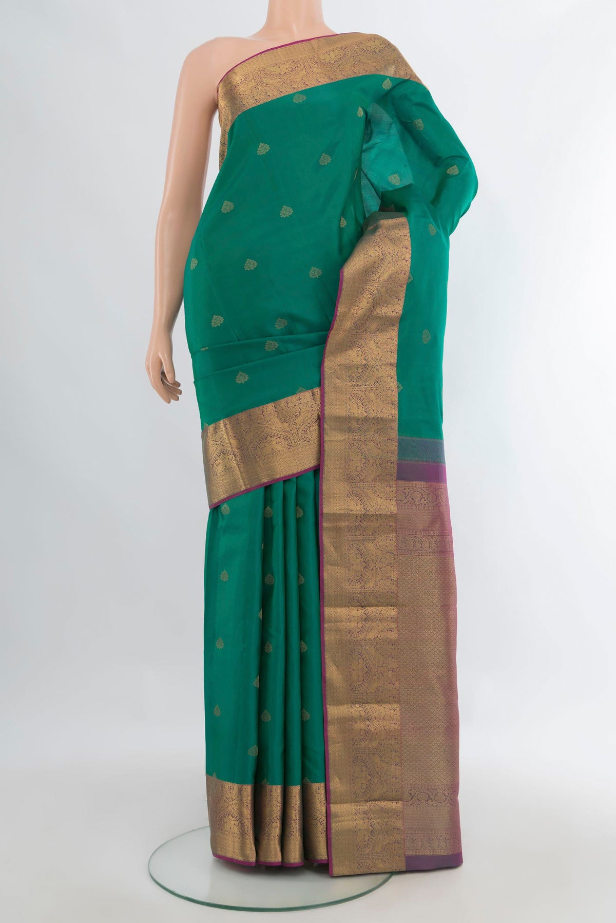 Pure Silk Sea Green Kanjivaram Saree with Zari Butta on the body and Zari Border.  displayed on a mannequin