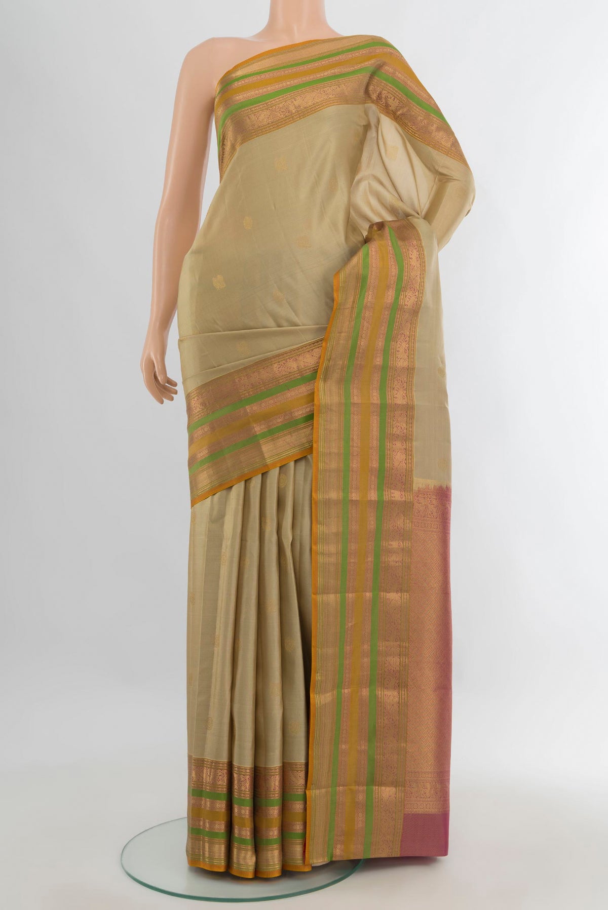 Pure Silk Beige Kanjivaram Saree with Zari Butta on the body and Zari Border.  displayed on a mannequin