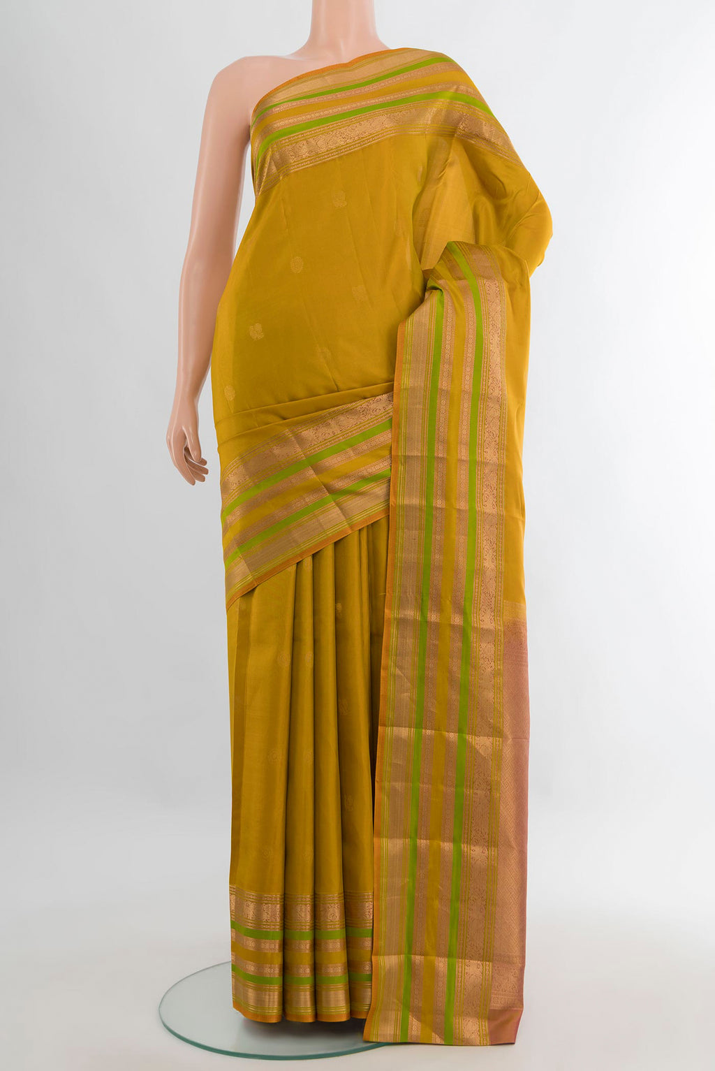 Pure Silk Mustard Kanjivaram Saree with Zari Butta on the body and Zari Border.  displayed on a mannequin