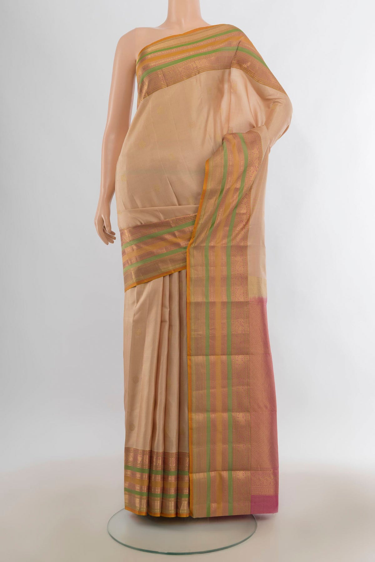 Pure Silk Beige Kanjivaram Saree with Plain Body and Zari Border.  displayed on a mannequin