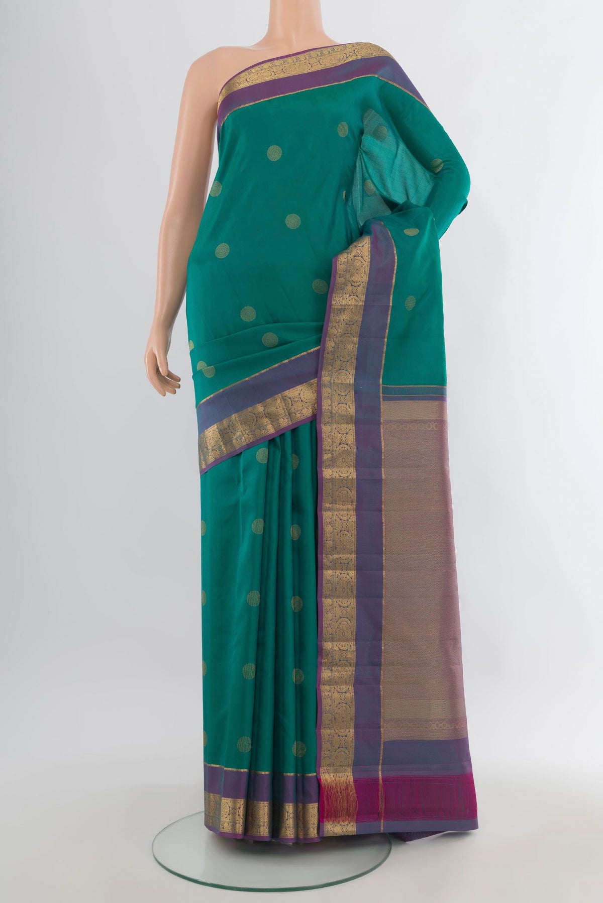Pure Silk Green Kanchipuram Saree with Zari Butta on the body and Zari Border.  displayed on a mannequin