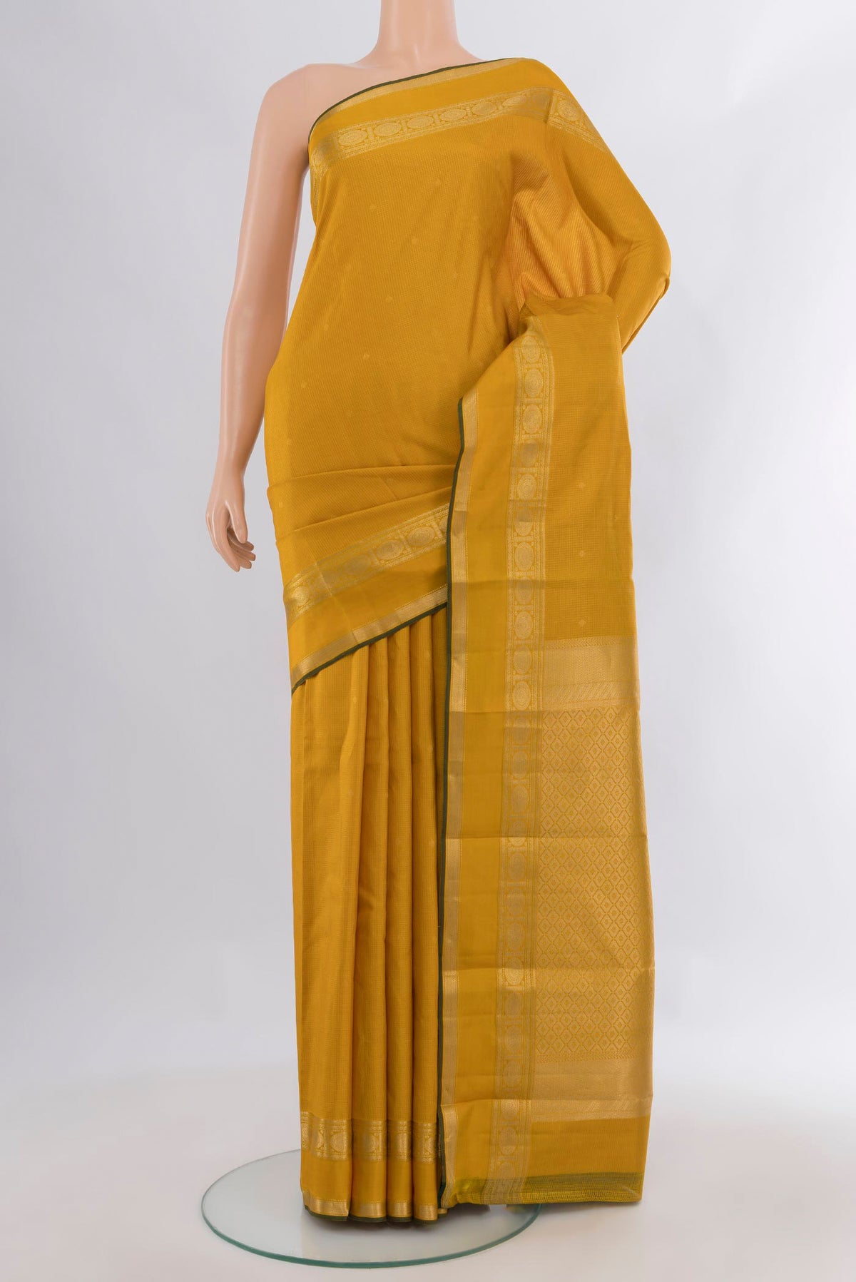 Pure Silk Mustard Kanjivaram Saree with Zari Butta on the body and Zari Border.  displayed on a mannequin