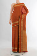 Pure Silk Orange Kanjivaram Saree with Zari Butta on the body and Zari Border.  displayed on a mannequin