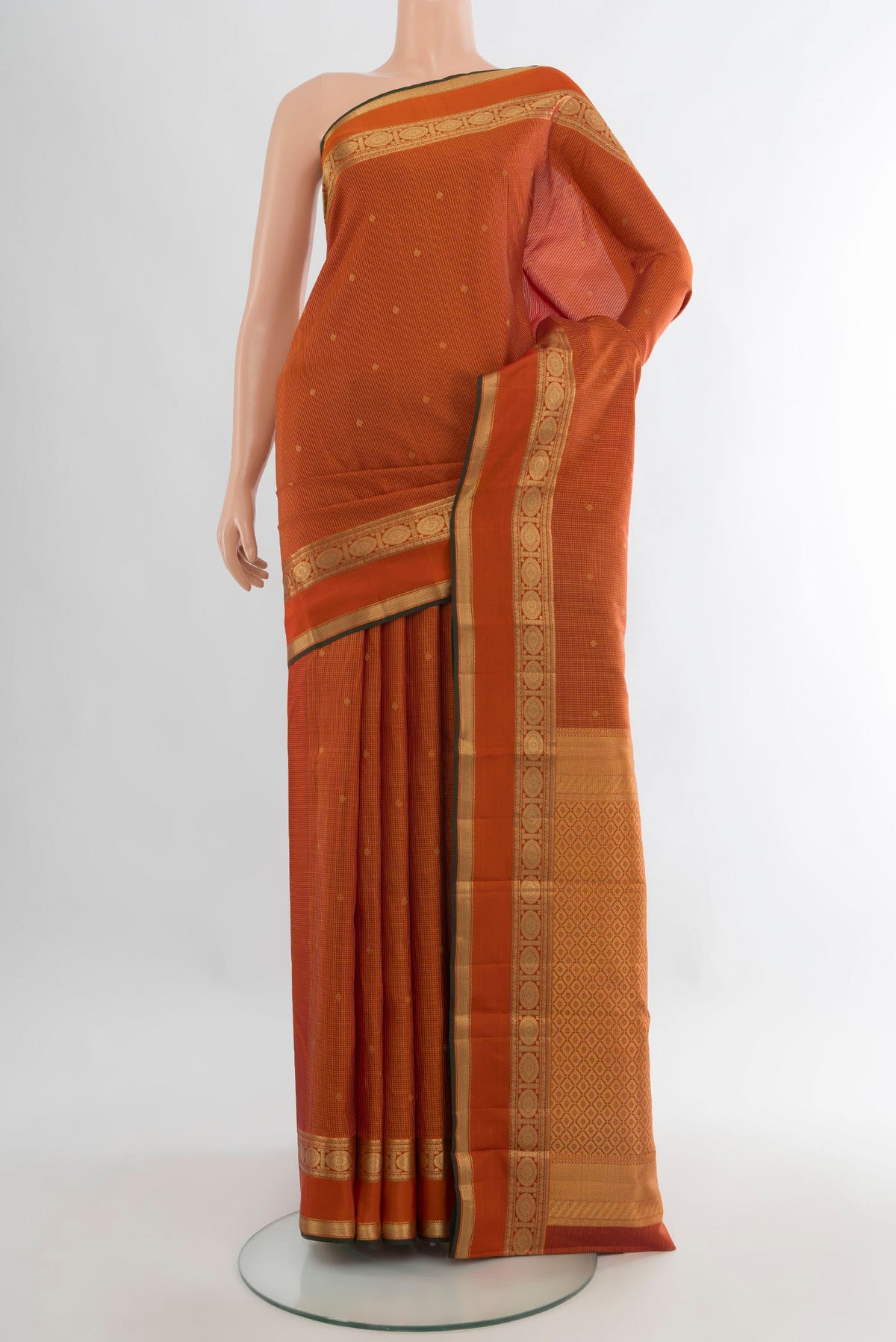 Pure Silk Orange Kanjivaram Saree with Zari Butta on the body and Zari Border.  displayed on a mannequin