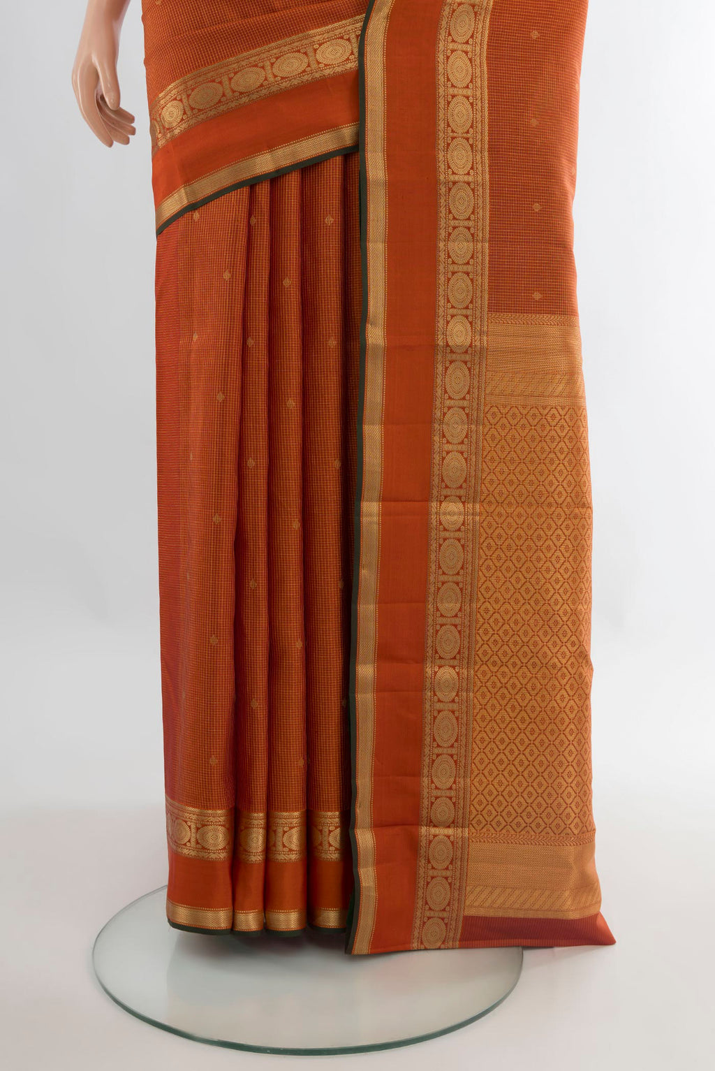 Pleats and pallu of Pure Silk Orange Kanjivaram Saree with Zari Butta on the body and Zari Border. 