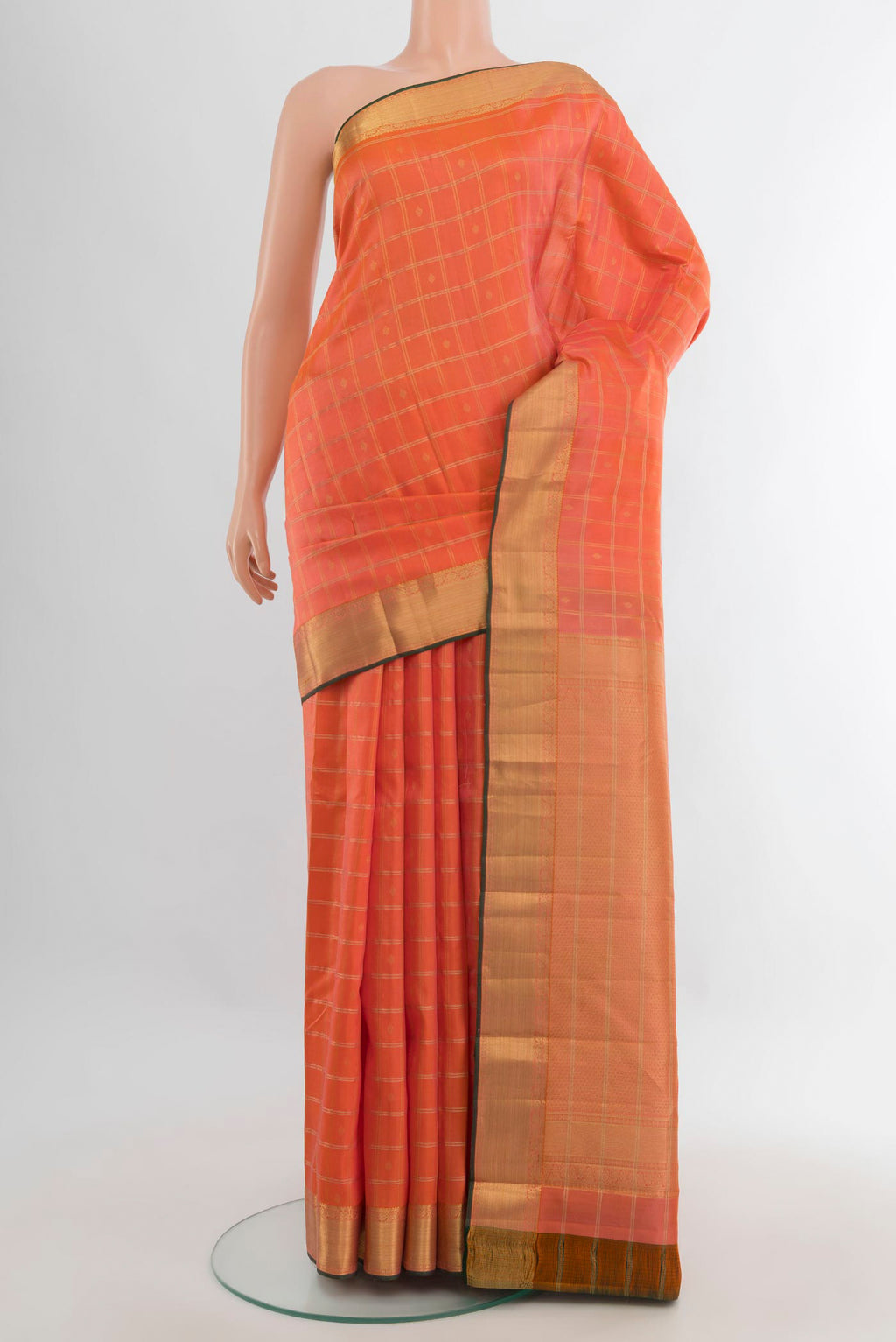 Pure Silk Orange Kanchipuram Saree with Checked design on the body and Zari Border.  displayed on a mannequin
