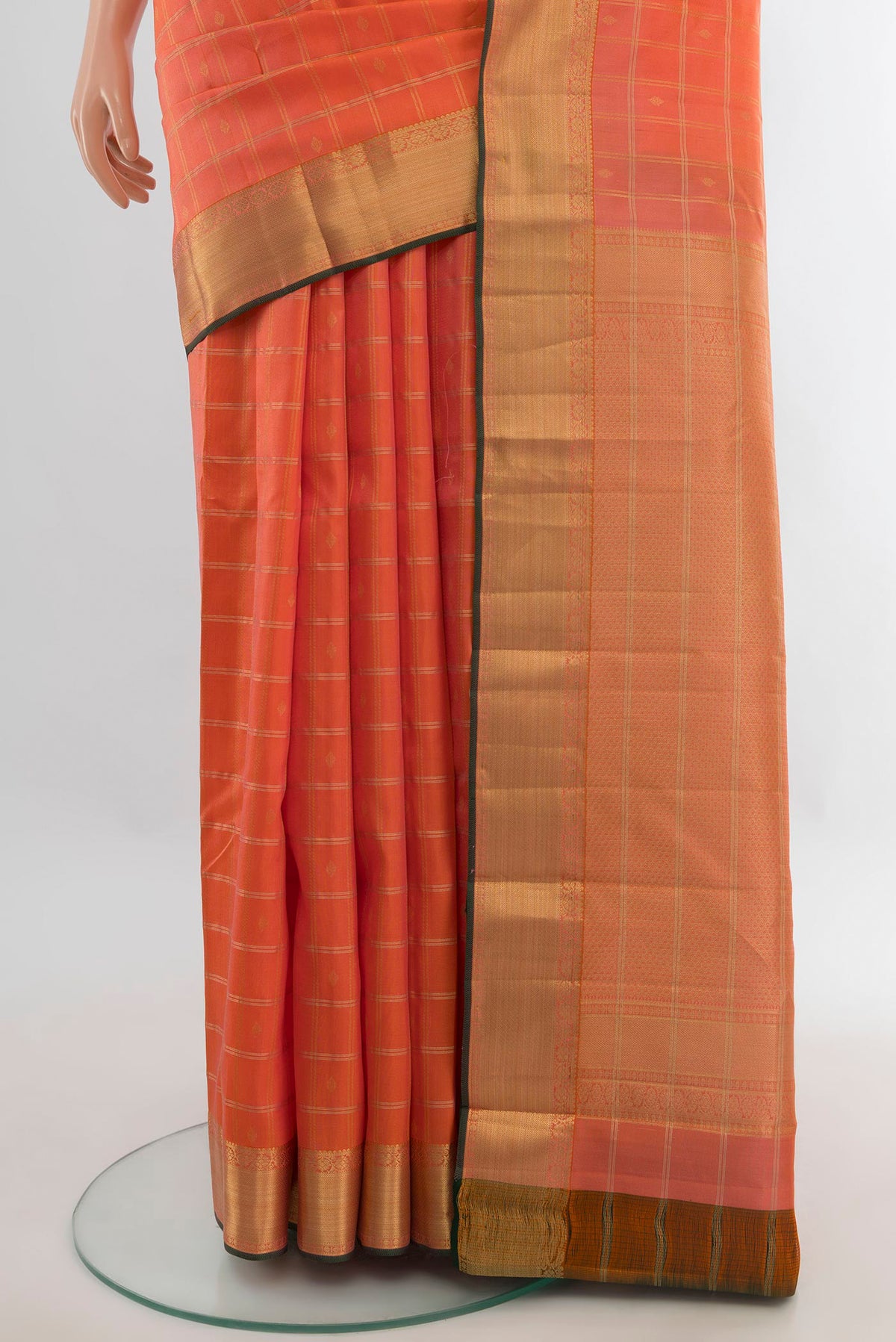 Pleats and pallu of Pure Silk Orange Kanchipuram Saree with Checked design on the body and Zari Border. 