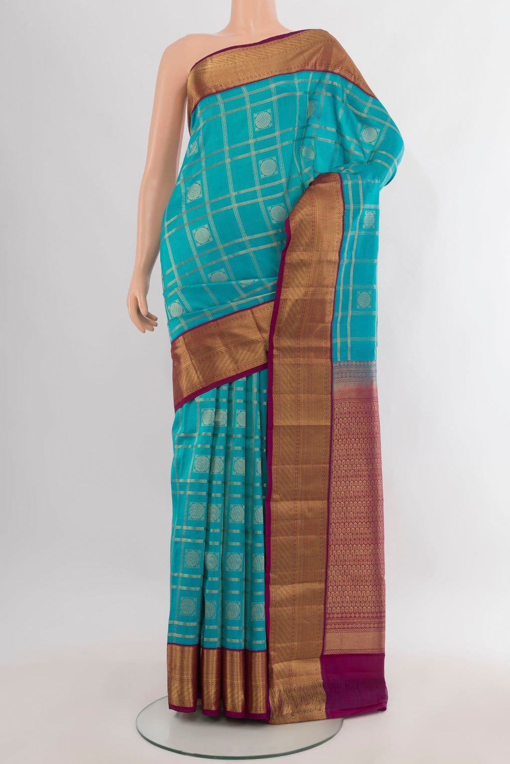 Pure Silk Turquoise Kanchipuram Saree with Checked design on the body and Zari Border.  displayed on a mannequin
