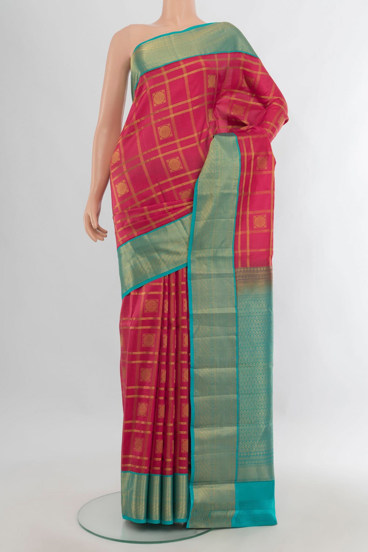 Pure Silk Coral Kanchipuram Saree with Checked design on the body and Zari Border.  displayed on a mannequin