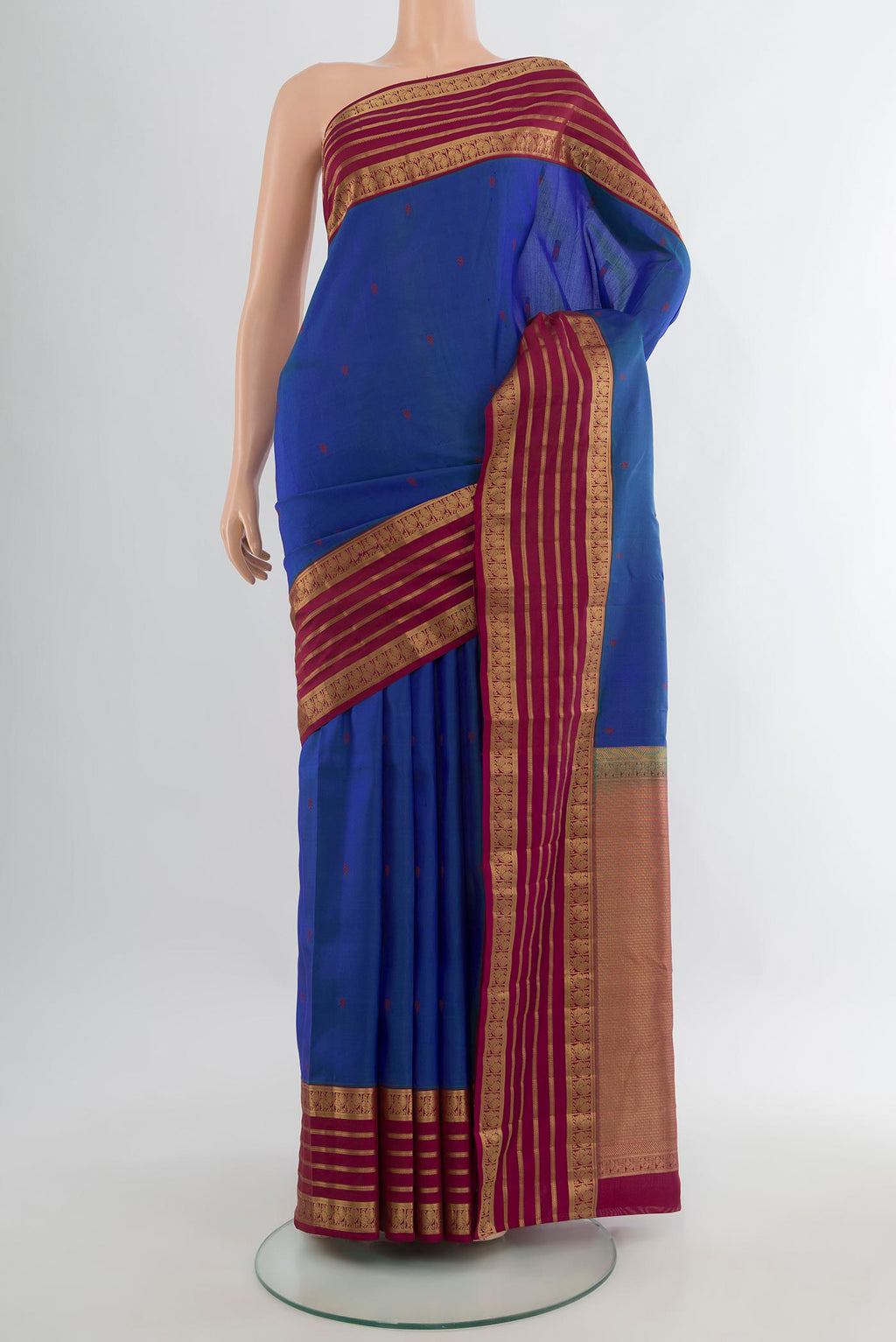 Pure Silk Blue Kanjivaram Saree with Thread Butta on the body and Zari Border.  displayed on a mannequin