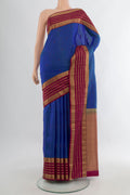 Pure Silk Blue Kanjivaram Saree with Thread Butta on the body and Zari Border.  displayed on a mannequin