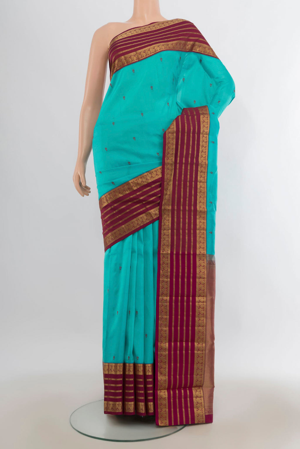 Pure Silk Turquoise Kanjivaram Saree with Thread Butta on the body and Zari Border.  displayed on a mannequin