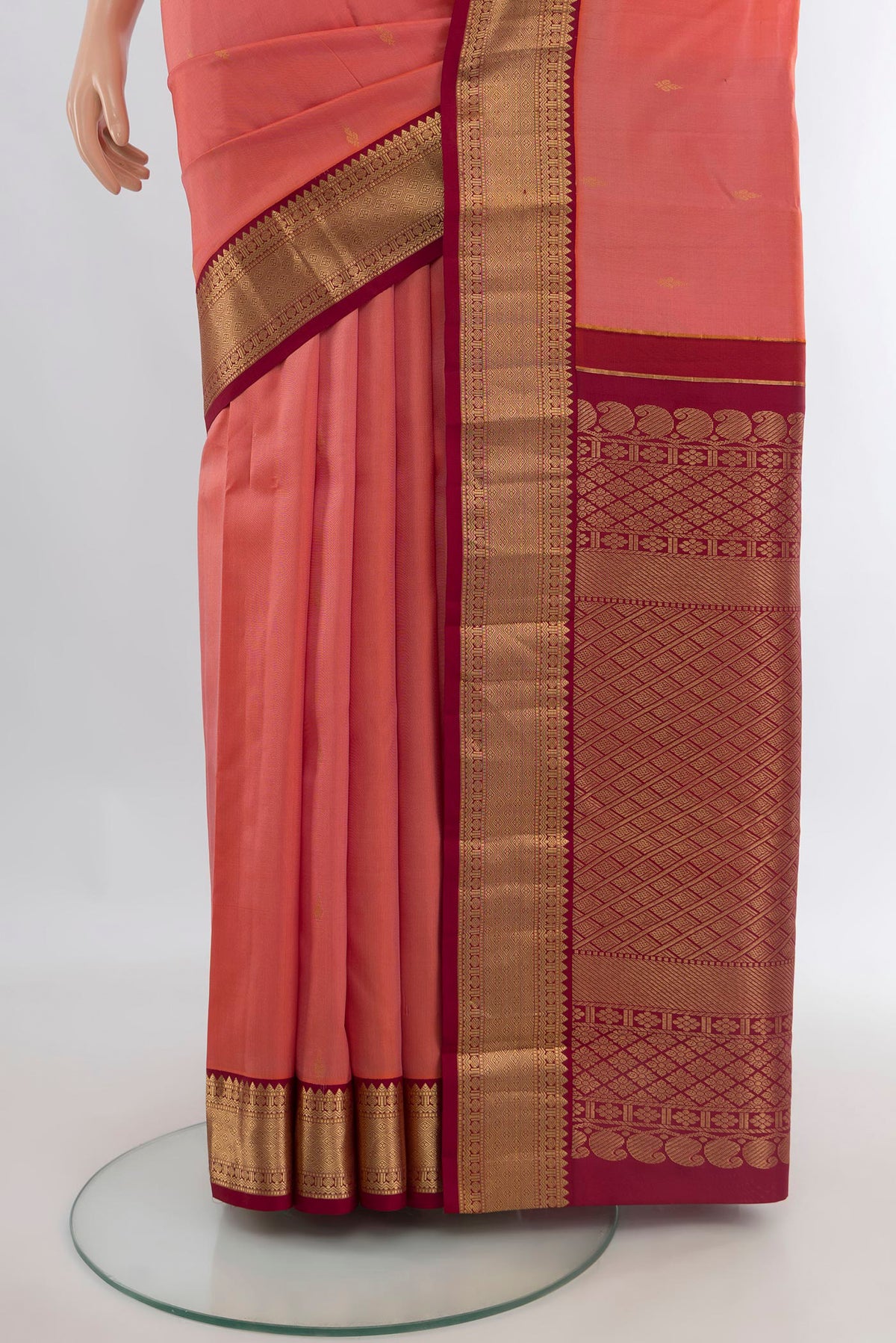 Pleats and pallu of Pure Silk Coral Kanchipuram Saree with Zari Butta on the body and Zari Border. 