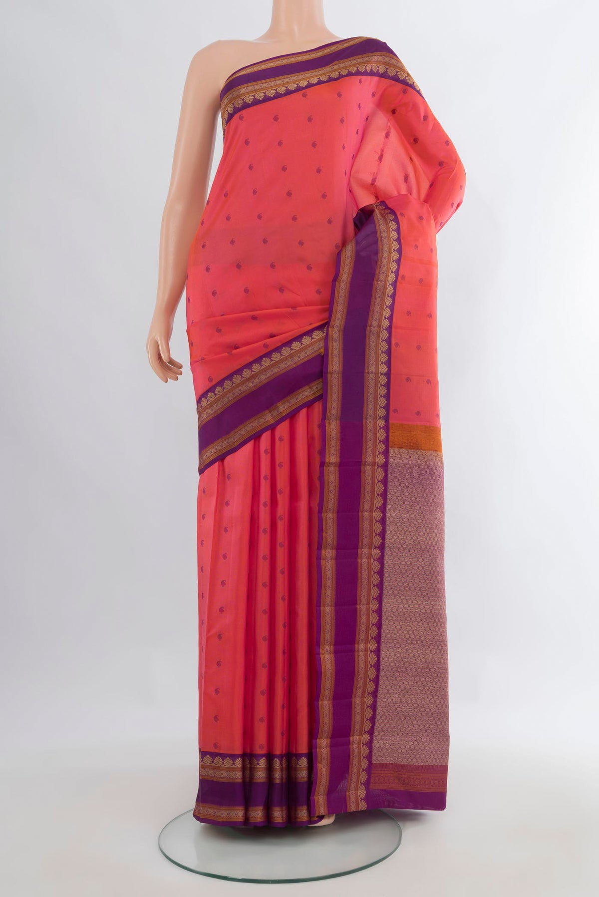 Pure Silk Coral Kanjivaram Saree with Thread Butta on the body and Thread Border.  displayed on a mannequin