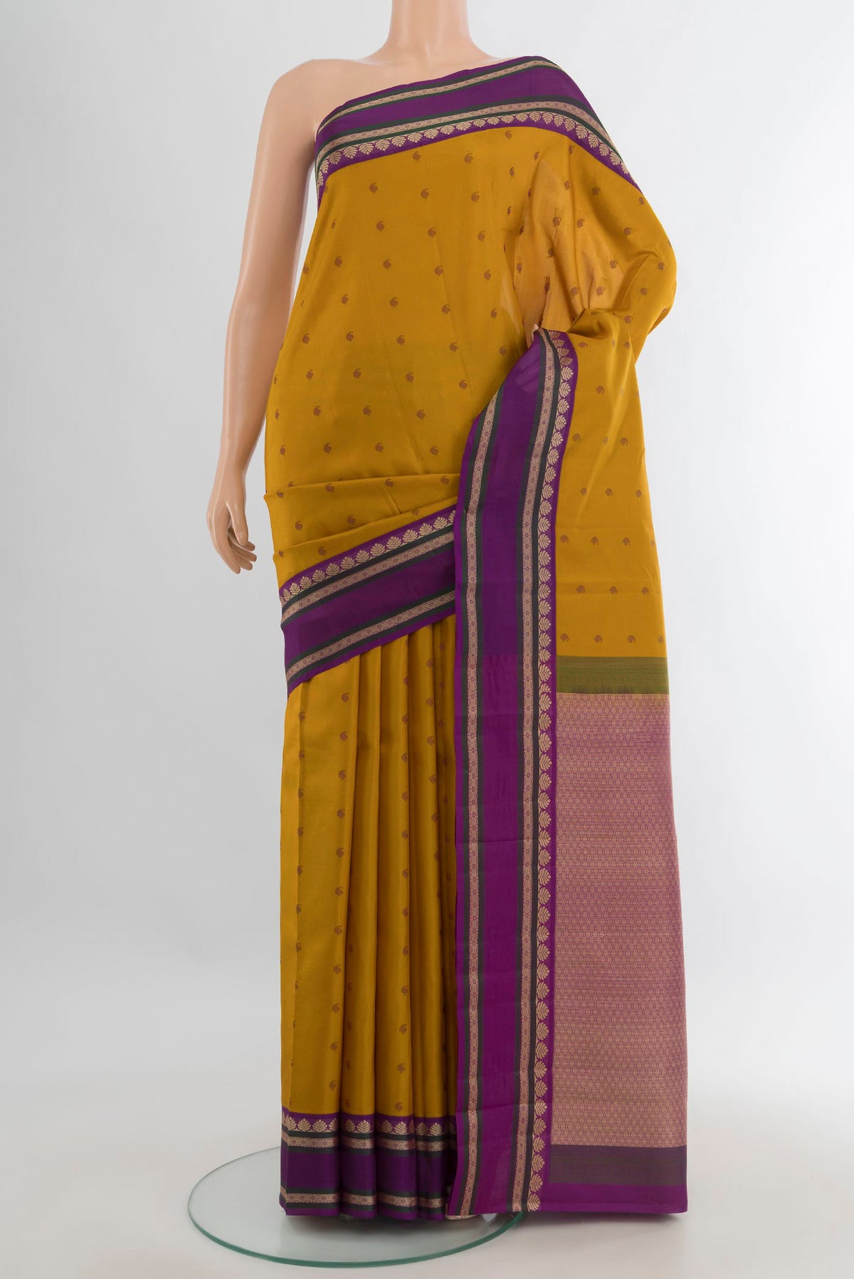 Pure Silk Mustard Kanjivaram Saree with Thread Butta on the body and Thread Border.  displayed on a mannequin