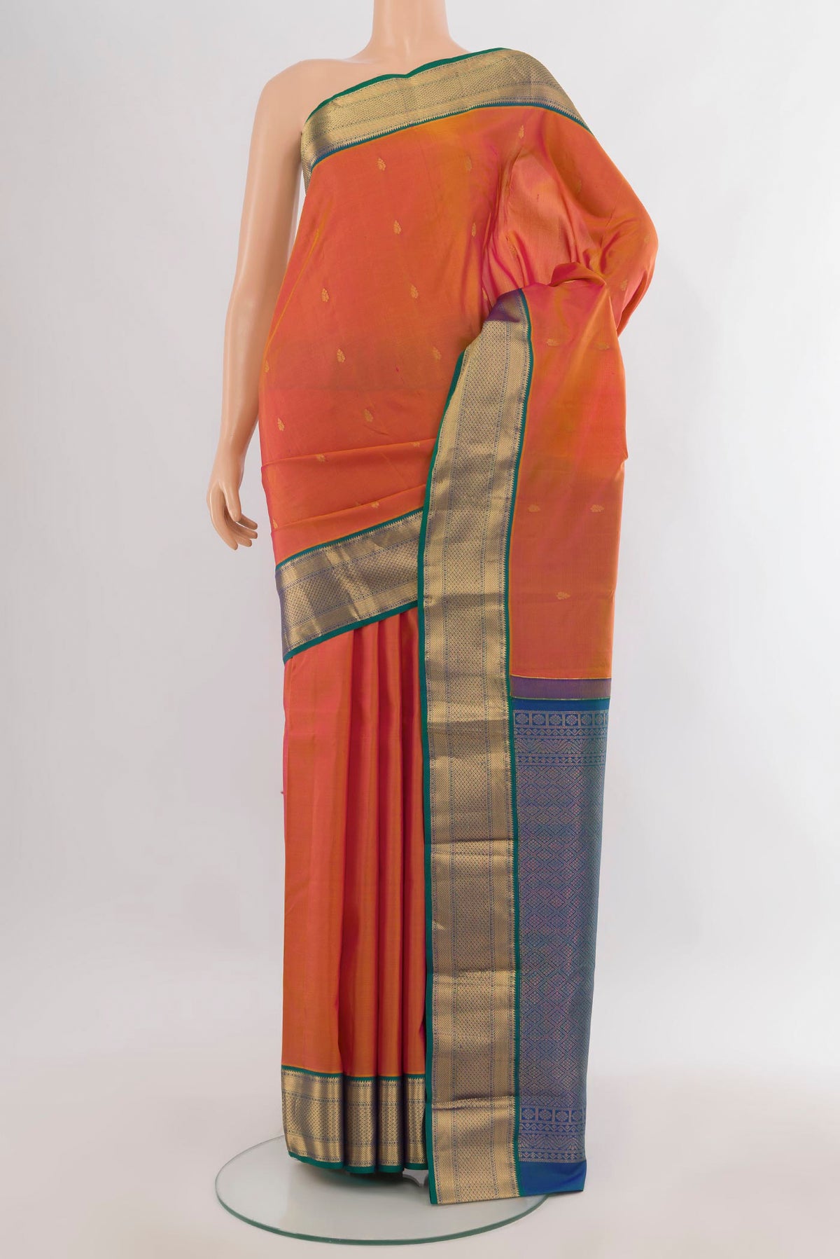Pure Silk Orange Kanjivaram Saree with Zari Butta on the body and Zari Border.  displayed on a mannequin