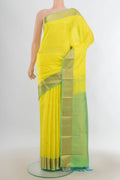 Pure Silk Lemon Yellow Kanchipuram Saree with Zari Butta on the body and Zari Border.  displayed on a mannequin
