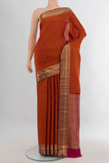Pure Silk Rust Kanchipuram Saree with Zari Butta on the body and Zari Border.  displayed on a mannequin